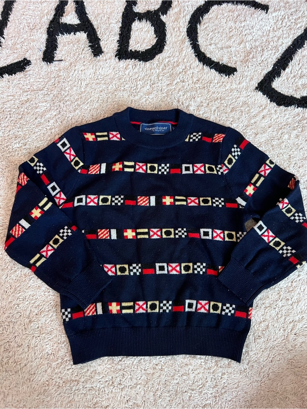 Vineyard Vines Navy Crewneck Sweater with nautical Red, White, Yellow Flag Motif